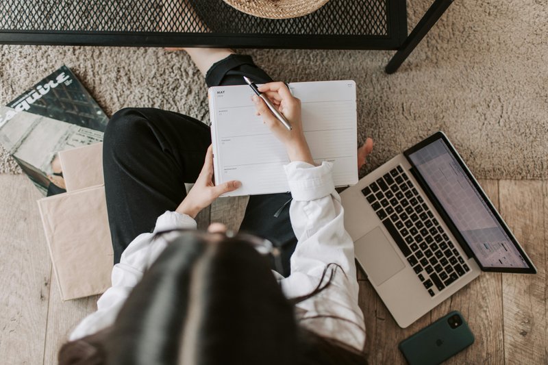 Woman managing finances with computer, phone and papers